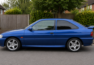 Blue-coupe-in-quiet-suburban-street-1